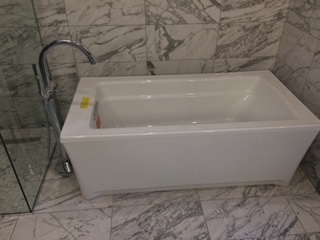 A bathtub in a bathroom Description automatically generated with medium confidence