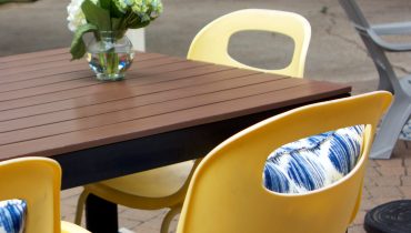 Yellow Patio furniture with blue pillows