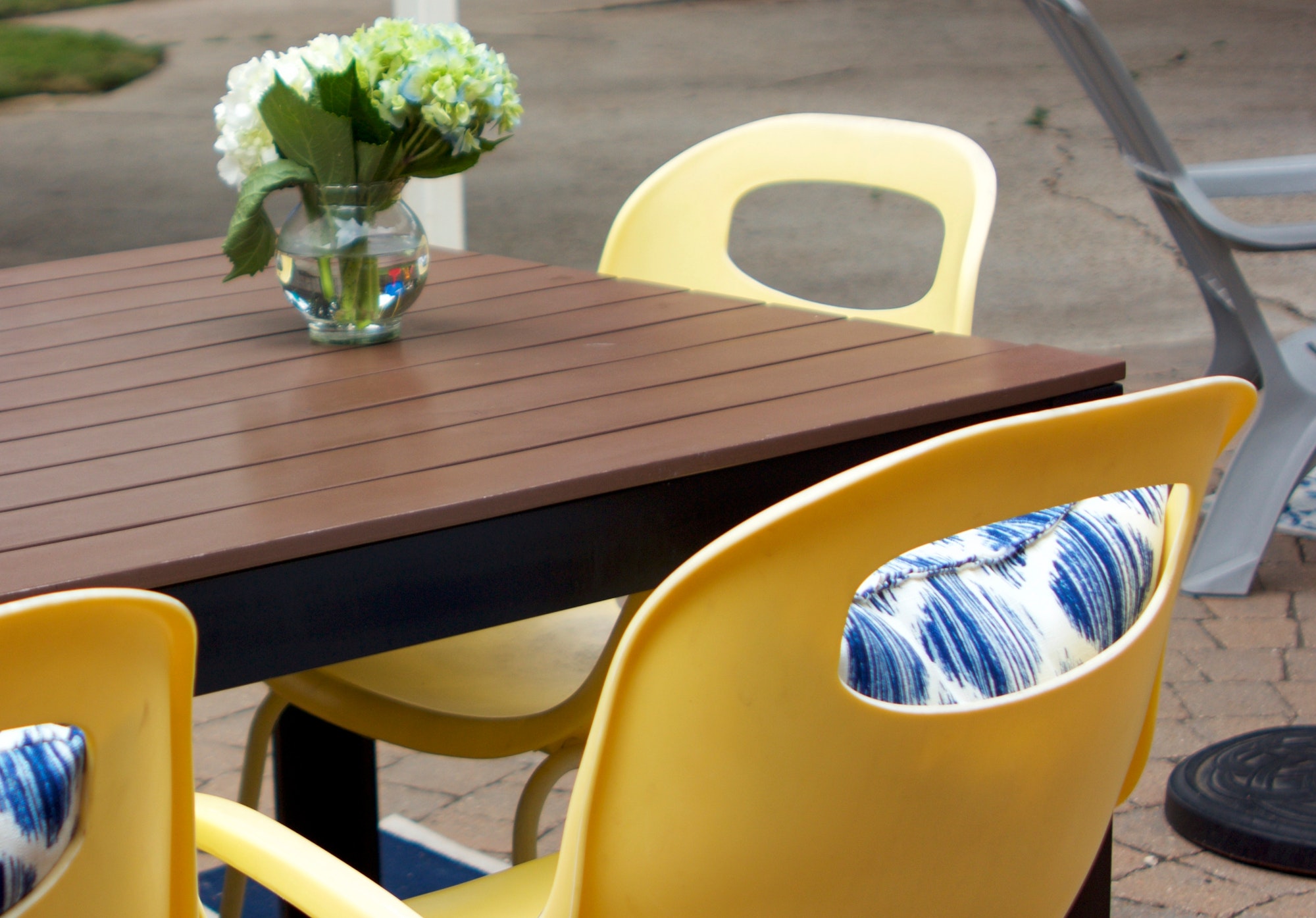Yellow Patio furniture with blue pillows